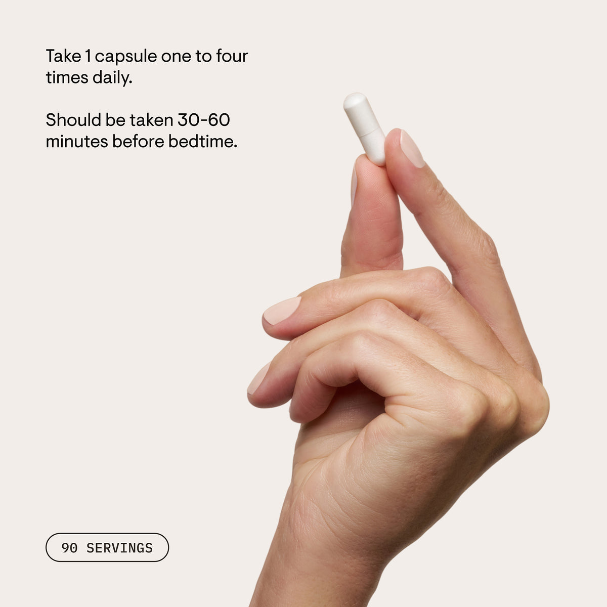 Hand holding a Magnesium Glycinate capsule beside usage instructions