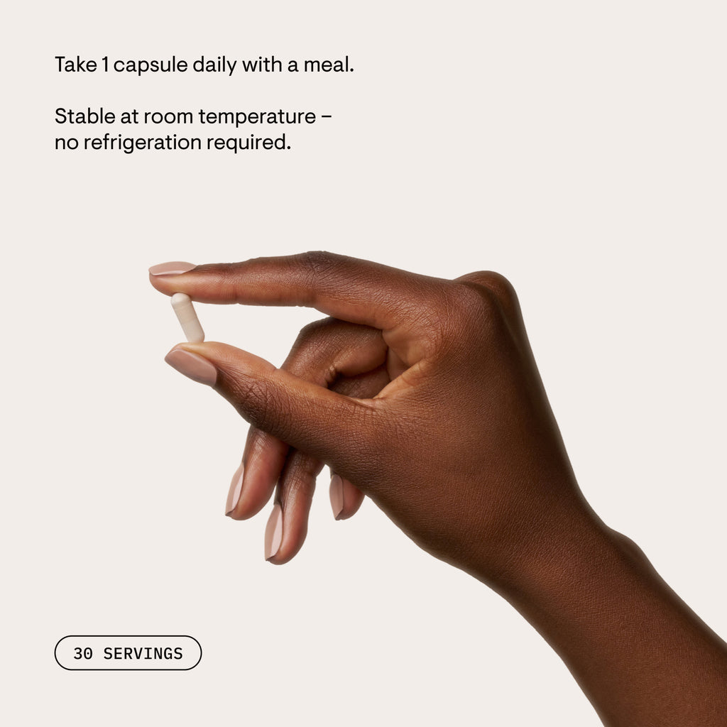 Hand holding a Protein Optimizer capsule beside usage instructions
