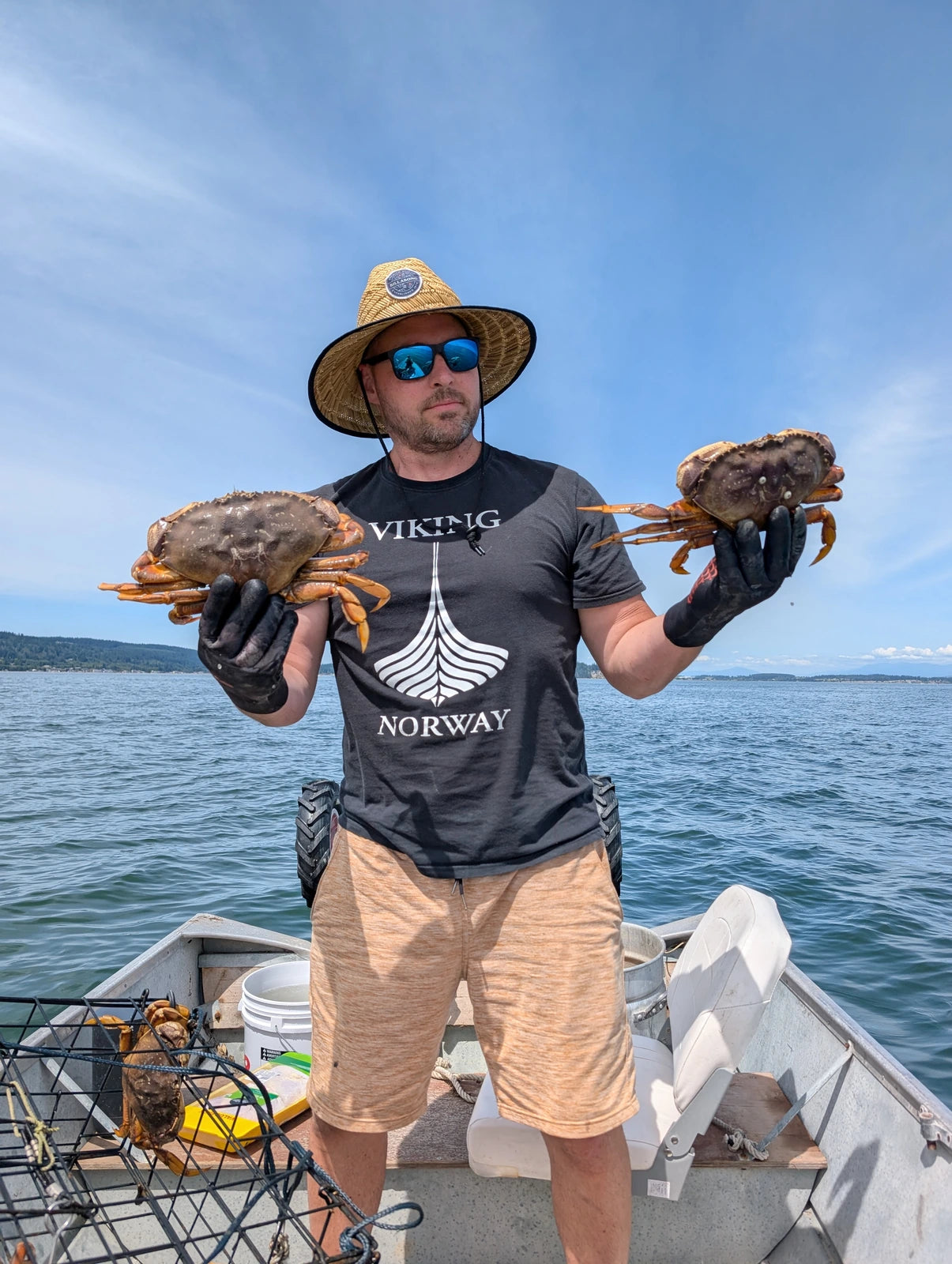 Preston on a boat holding two crabs